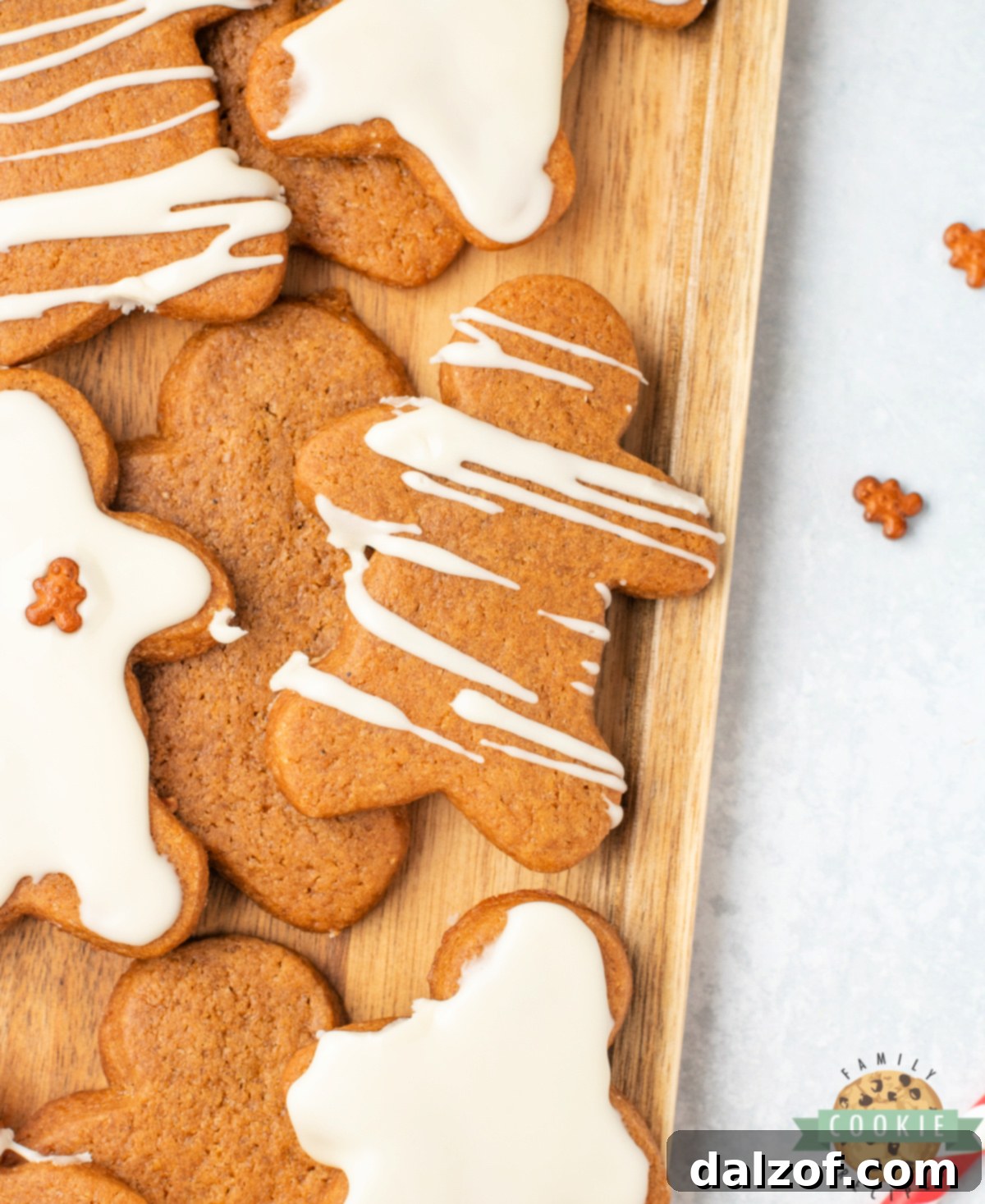 A festive tray of gingerbread men cookies, each beautifully coated with a smooth layer of maple icing, ready for holiday gifting and sharing.
