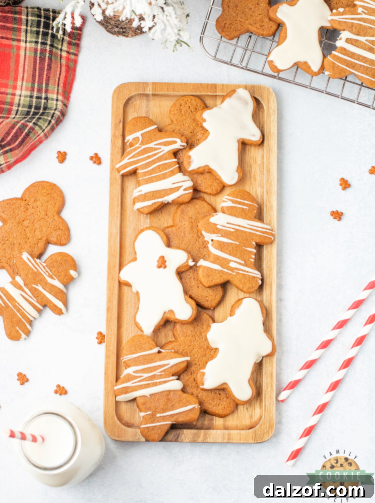 Delightful gingerbread men cookies beautifully coated with a thin, glossy layer of sweet maple icing, perfect for a festive treat.