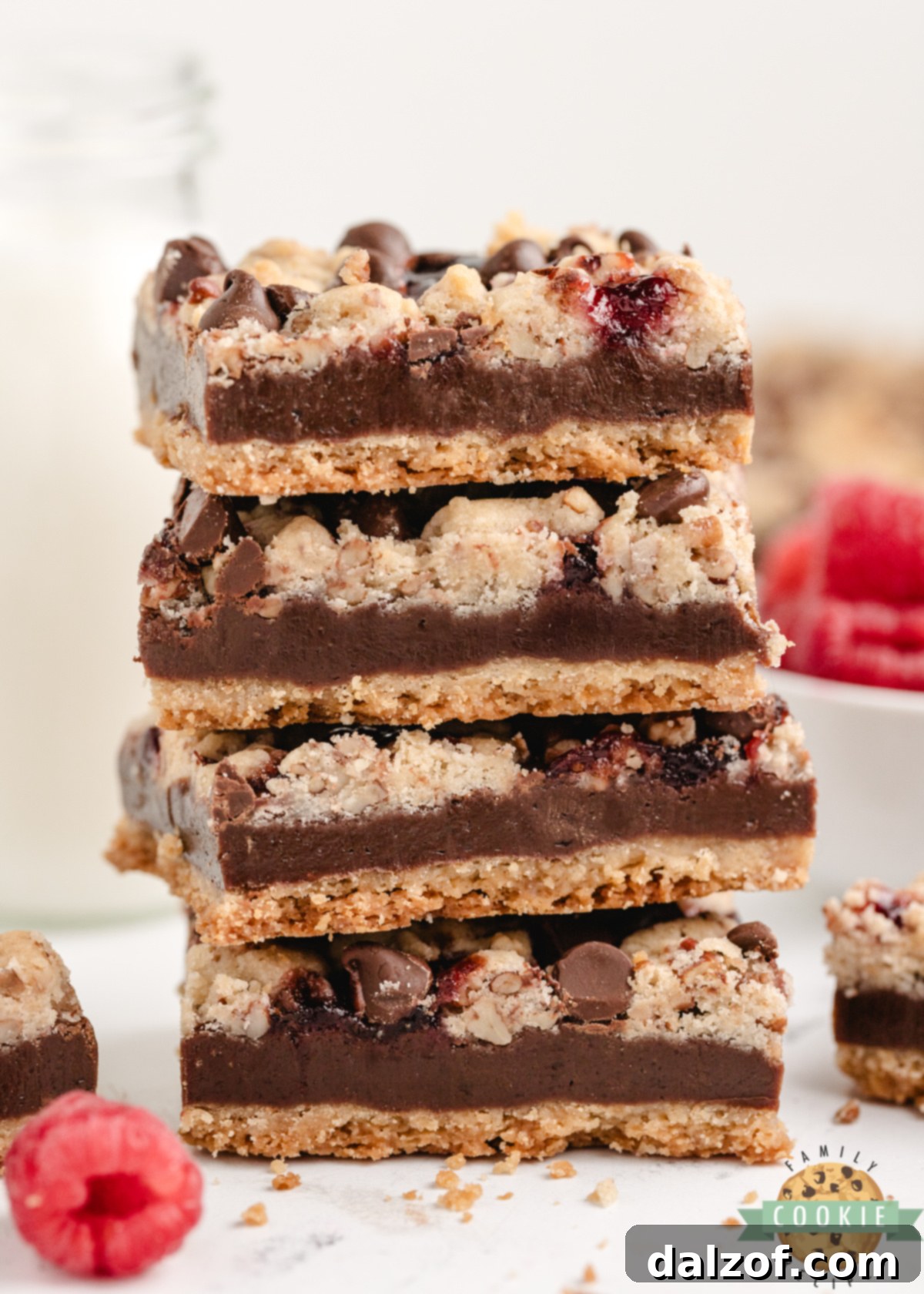 Stack of chocolate raspberry shortbread bars showing layers of crust and crumb topping.
