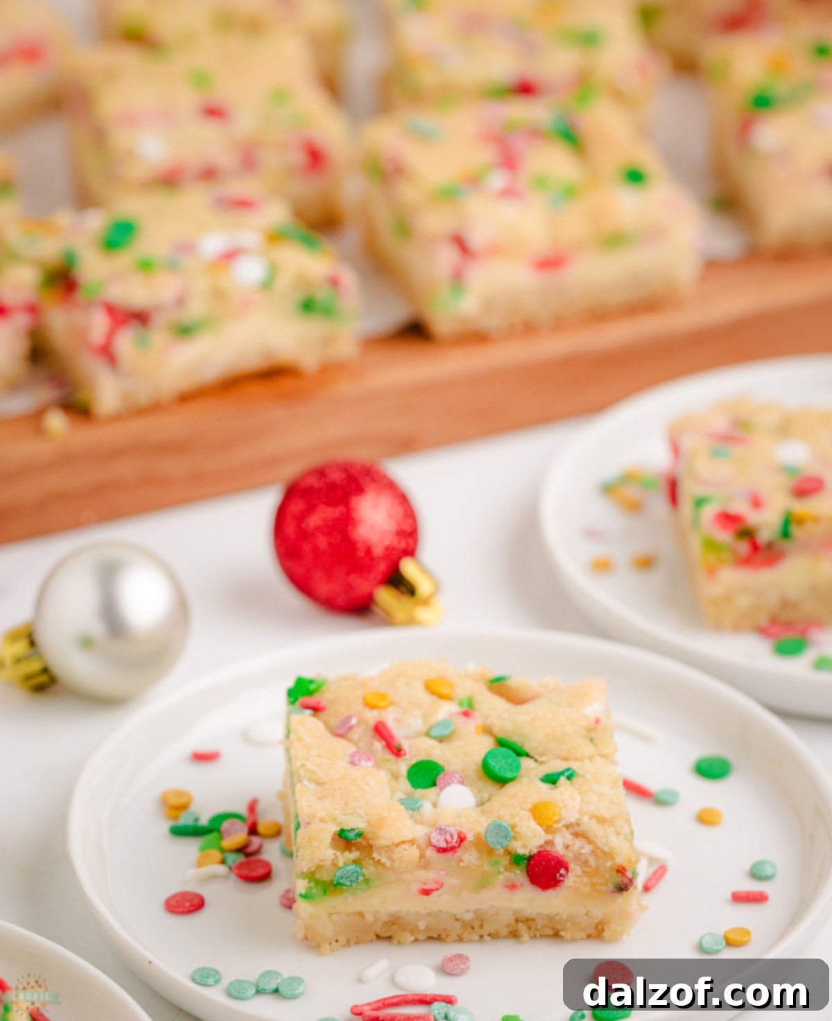 Christmas sugar cookie bars with cheesecake filling cut into squares