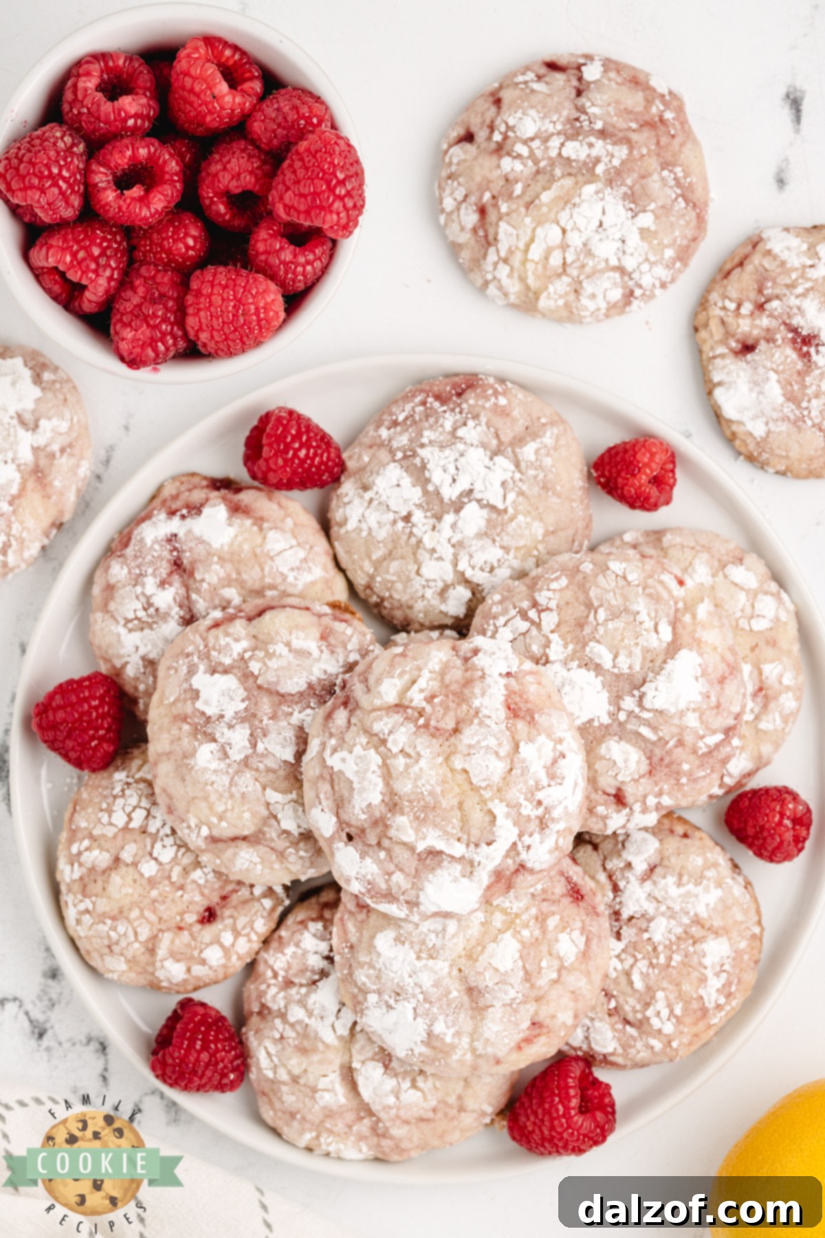 Lemon raspberry cookies with crackly powdered sugar tops.
