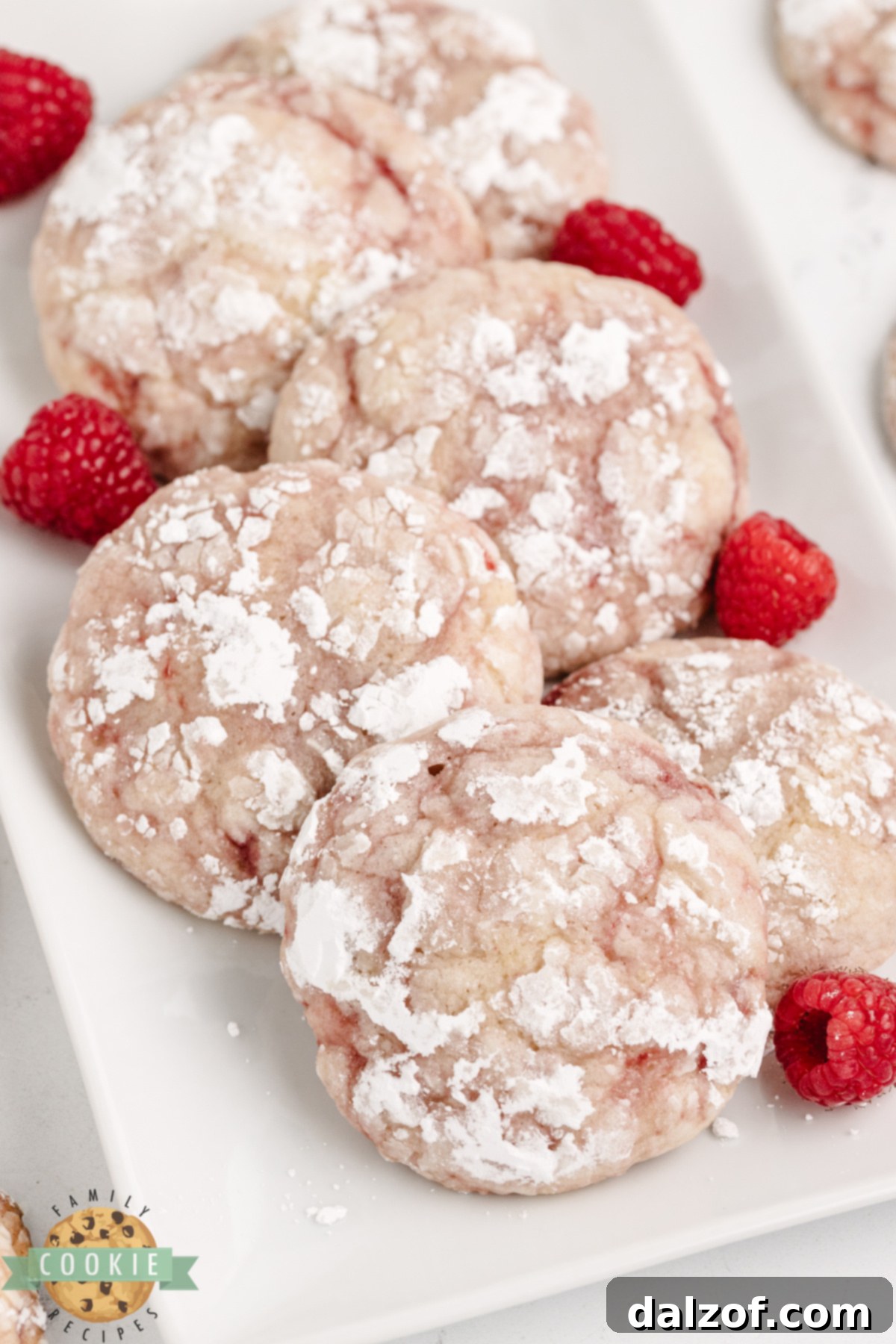 Lemon raspberry crinkle cookies dusted with powdered sugar.