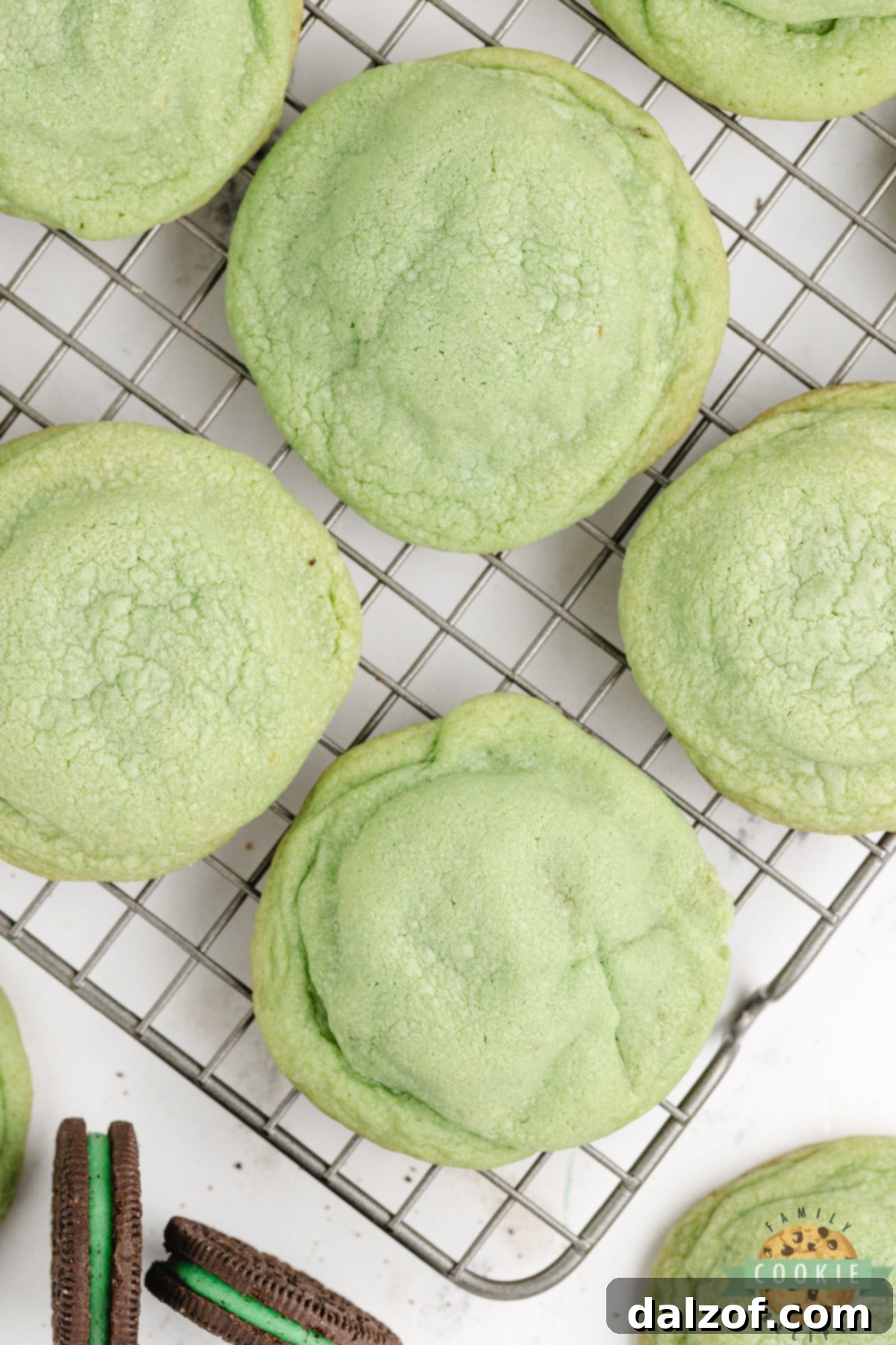 Homemade mint Oreo stuffed cookies cooling on a wire rack.