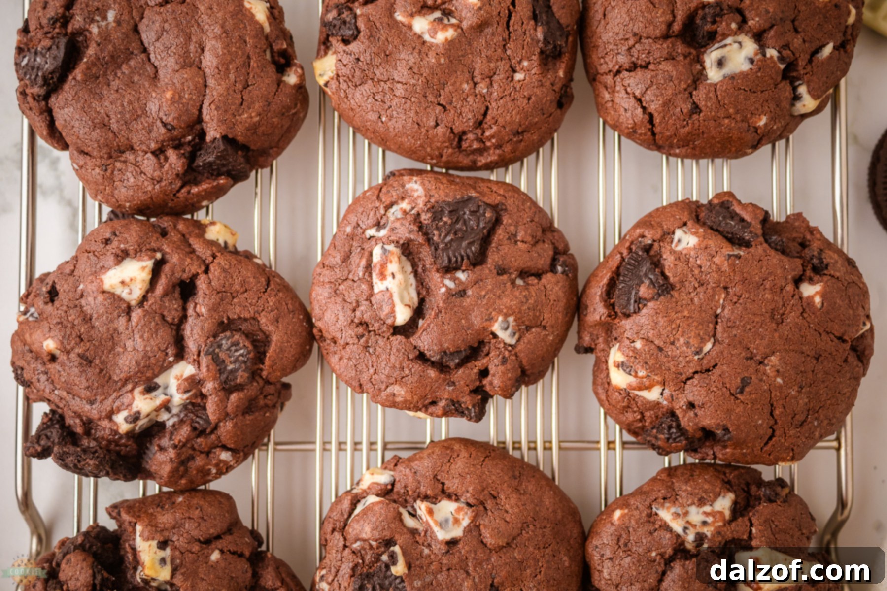 Delicious chocolate cookies and cream cookies on a baking sheet, ready to be enjoyed.