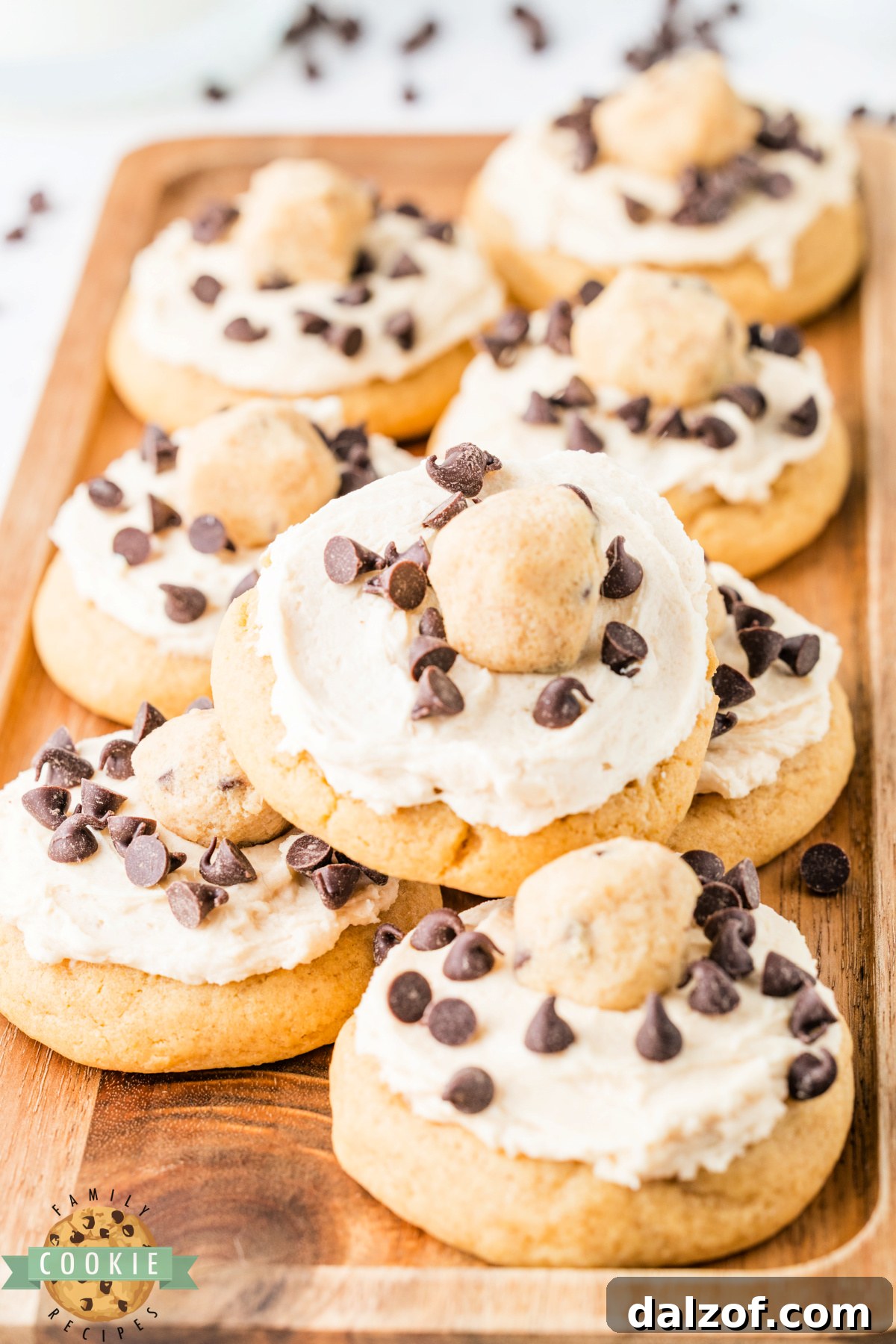 Batch of cookie dough frosted cookies loaded with edible cookie dough pieces and mini chocolate chips