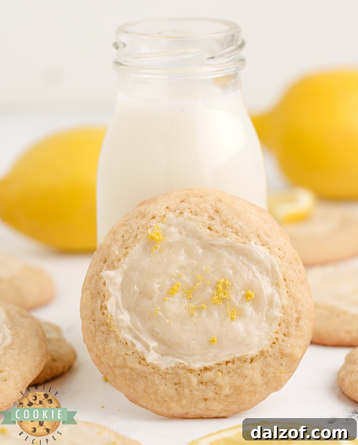 Lemon Cheesecake Cookie topped with lemon zest and propped up next to a bottle of milk.