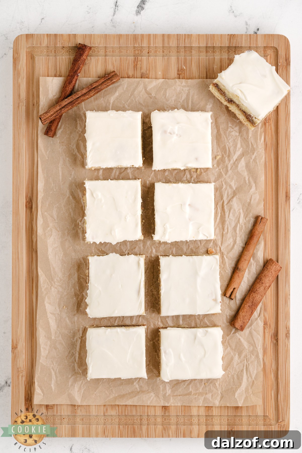 Sliced cinnamon roll sugar cookie bars showing the soft sugar cookie base, cinnamon filling, and frosting drizzle.